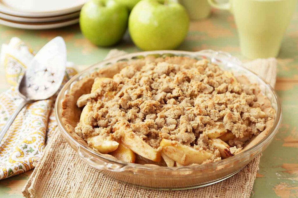Gluten-Free Apple Crumb Pie displayed with green apples