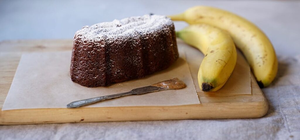 Banana Teff Cake pictured with fresh bananas