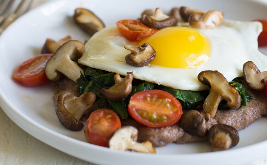 Instant Pot Teff Breakfast Cheese Grits topped with a fried egg