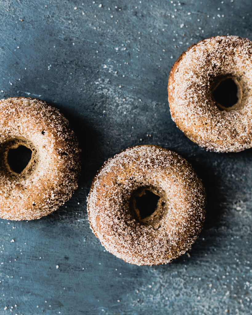 Three Gluten-Free Pumpkin Spice Donuts displayed on counter-top