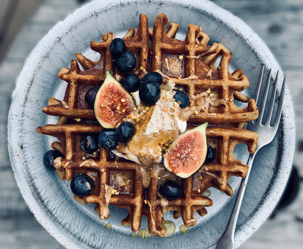 Crispy Teff Waffles adorned with figs and blueberries