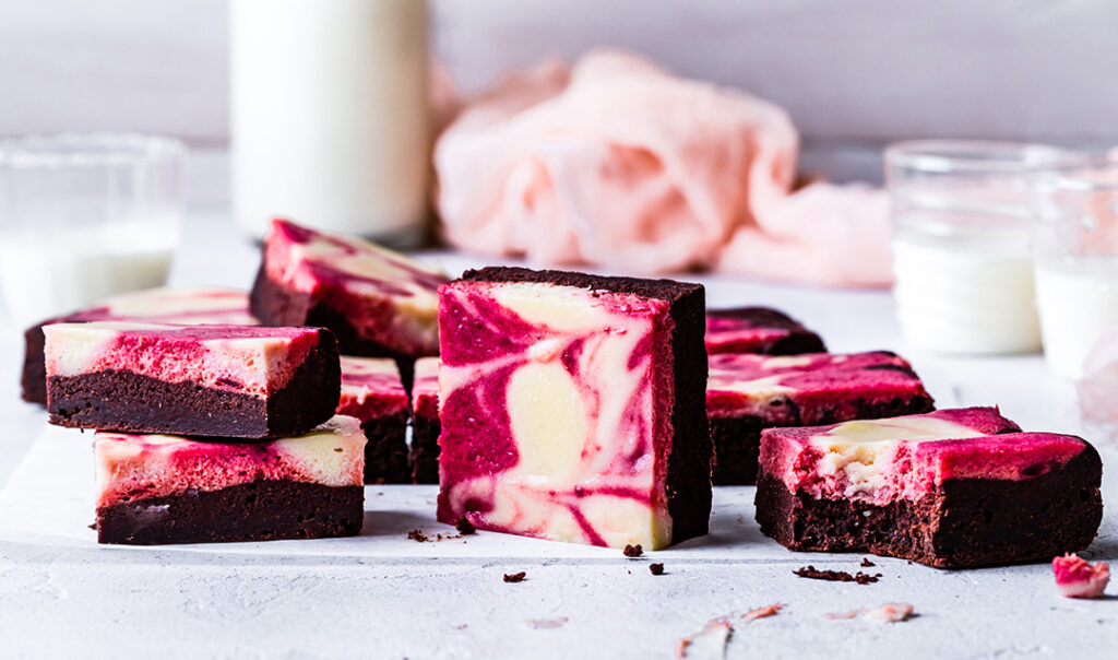Gluten-free red velvet cheesecake cut in squares and stacked