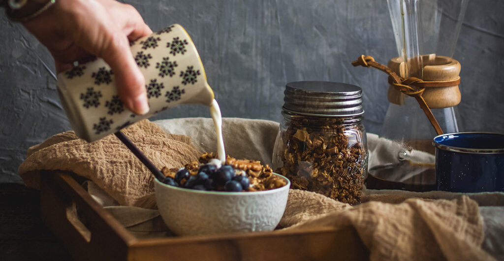 milk poured over teff gluten-free banana bread granola