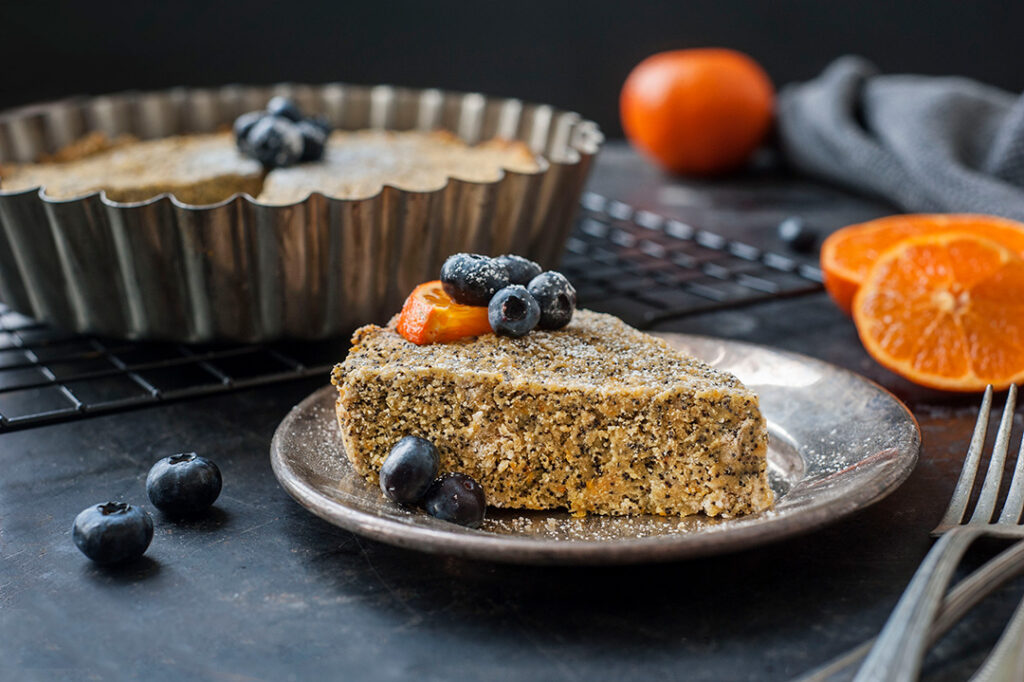 Slice of Orange Poppy Seed Cake with berries on top