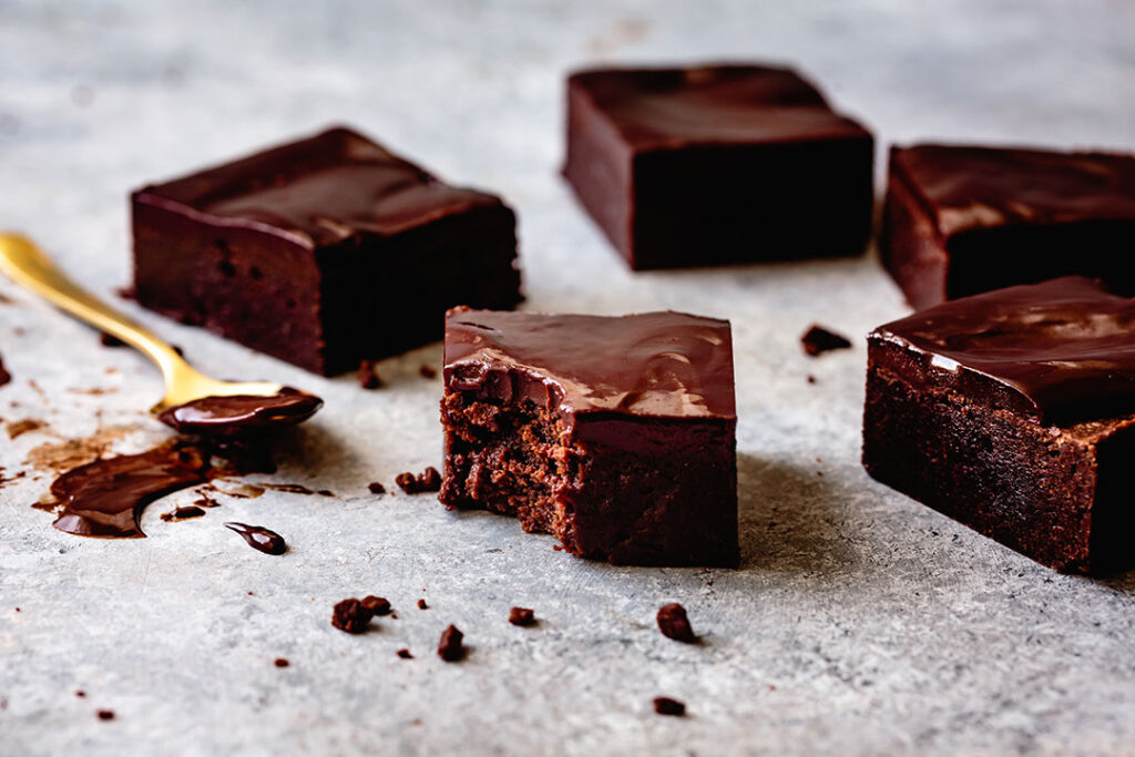 Gluten-Free Ganache Brownies, one with a bite missing