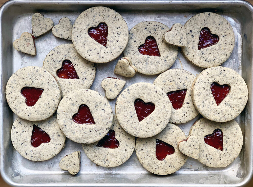 Tray of Round Black Sesame Linzer Cookies with heart in center