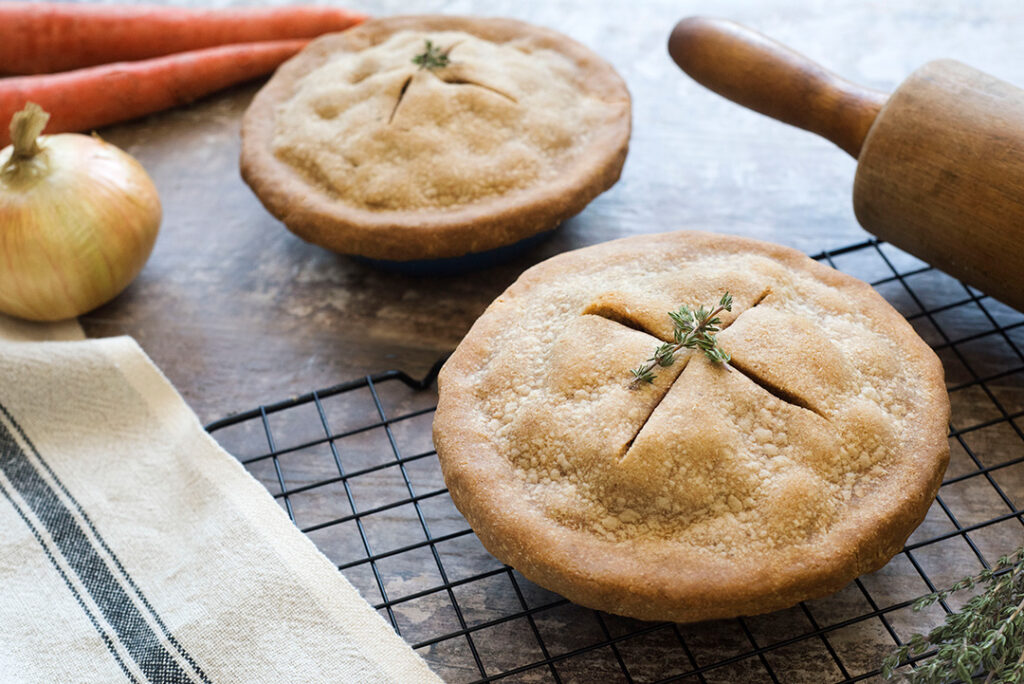 Two Gluten-Free Vegetable Pot Pies displayed beside rolling pin