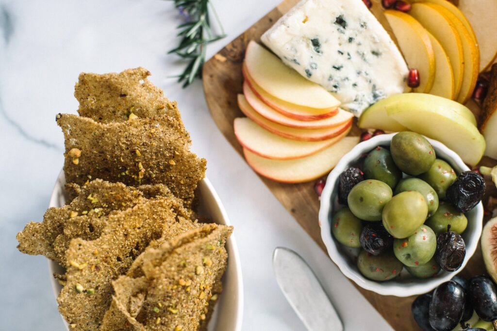 Pistachio Amaranth & Teff Crisps Pistachio Crisps featured with olives and cheese