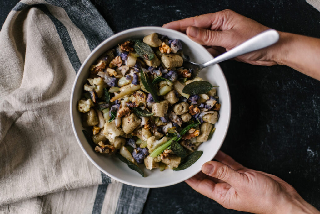 Gnocchi with Cauliflower, Sage & Walnuts in bowl