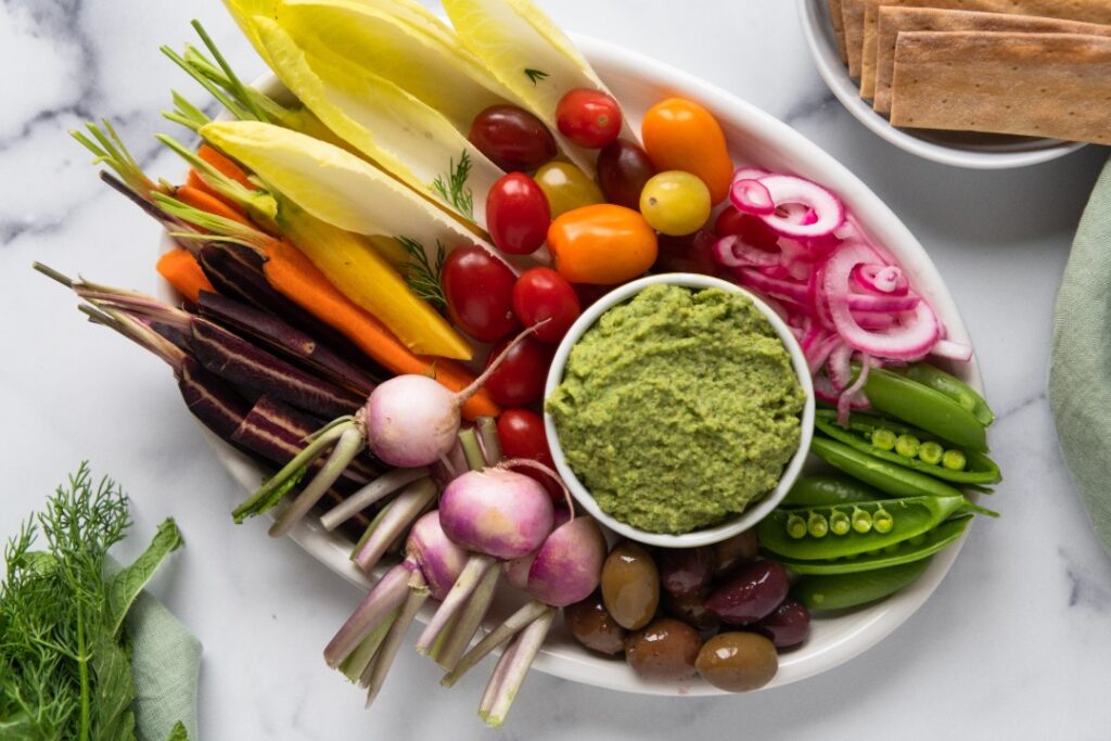 teff dip on a platter surrounded by vegetables