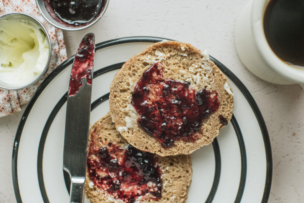Gluten-Free English Muffins displayed with jam and a cup of coffee