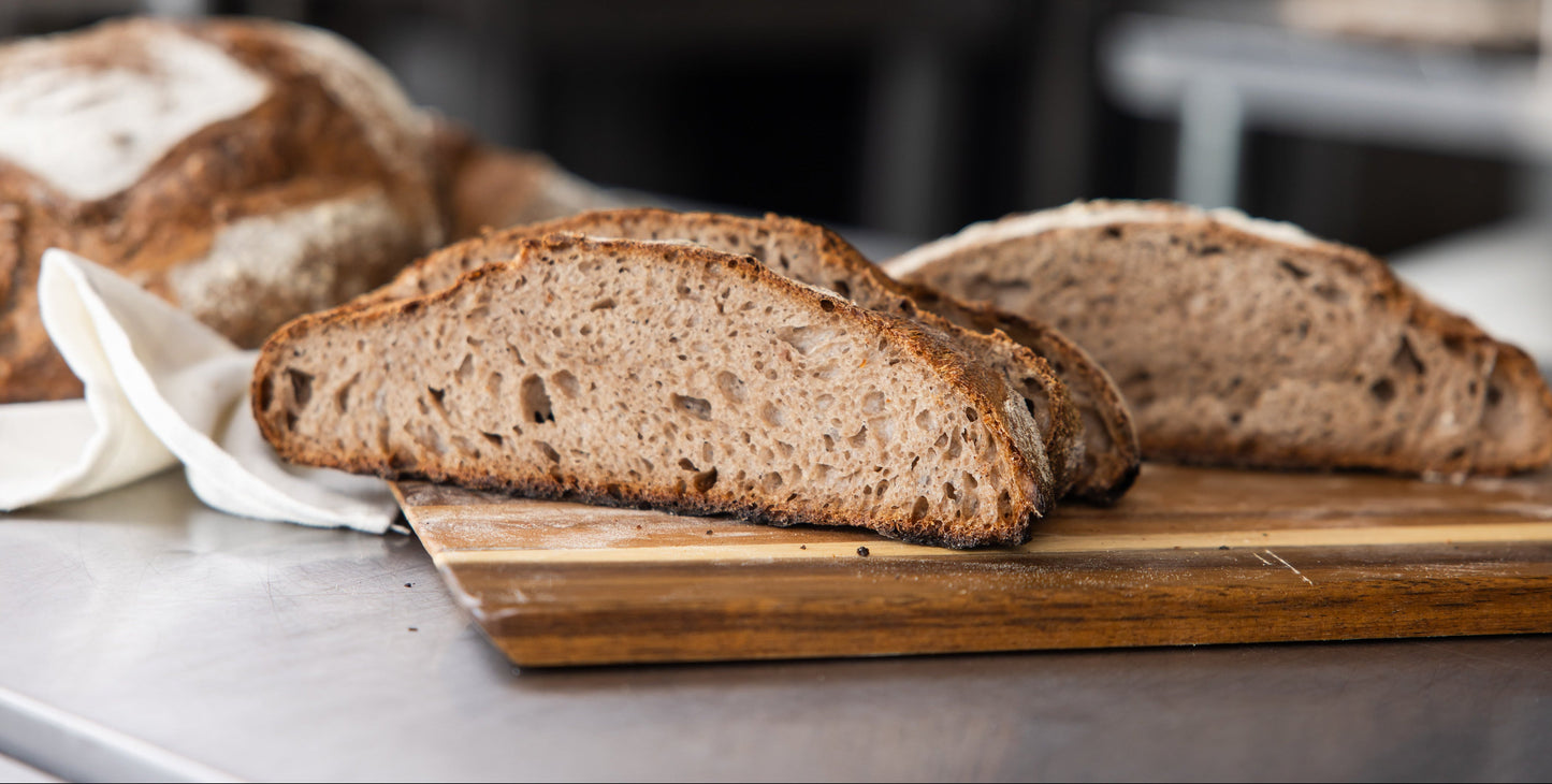 Sliced bread on a wooden cutting board with a blurred background